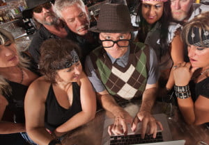 Image of people around a keyboard looking at agile team metrics and Product Development Metrics