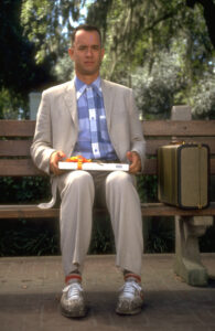 Forrest Gump on a park bench with a box of chocolates