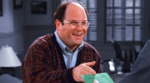 Photograph of George Constanza handing over his Personal Development Plan